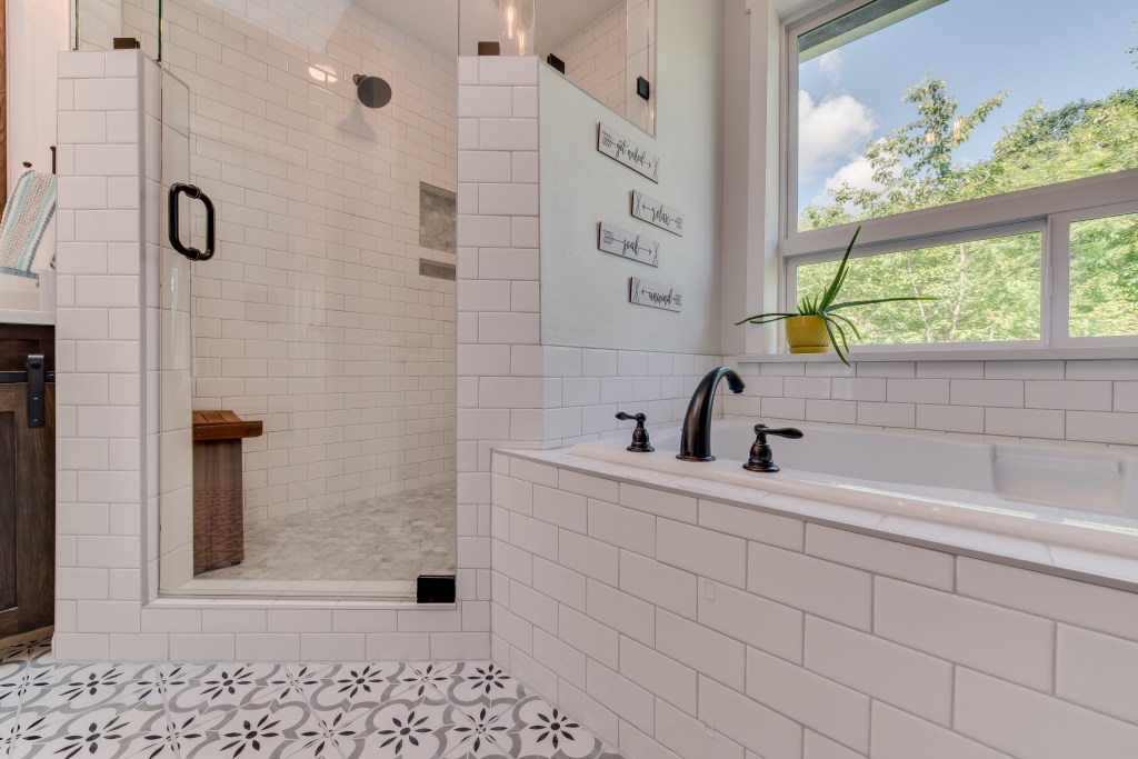 custom shower and drop in tub with subway tiles