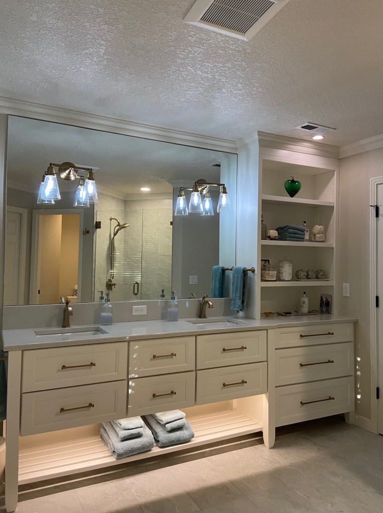 custom built in vanity with two sinks and brushed gold fixtures